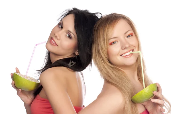 Women drink juice of citrus — Stock Photo, Image