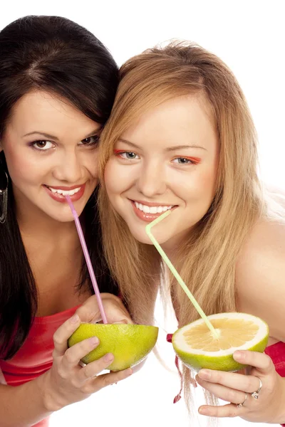 Blonde and the brunette drink juice — Stock Photo, Image
