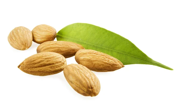Almonds and a green leaf — Stock Photo, Image