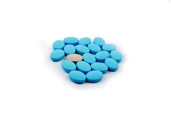 Comprimido blanco entre azul —  Fotos de Stock