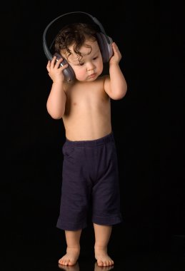 Baby with headphones. clipart