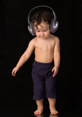 Dancing baby with headphones. clipart