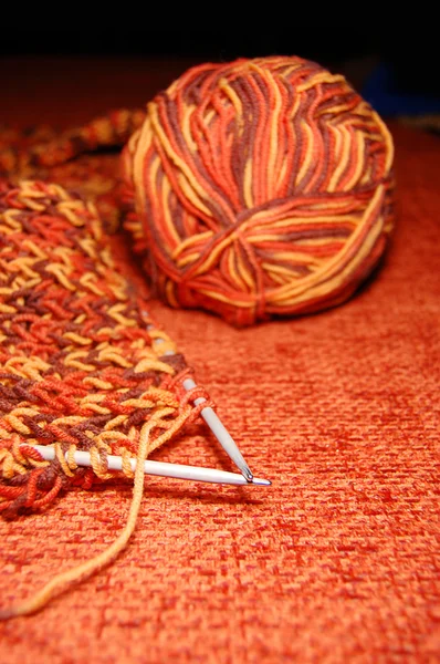 Orange balls of yarn and spades for knitting — Stock Photo, Image