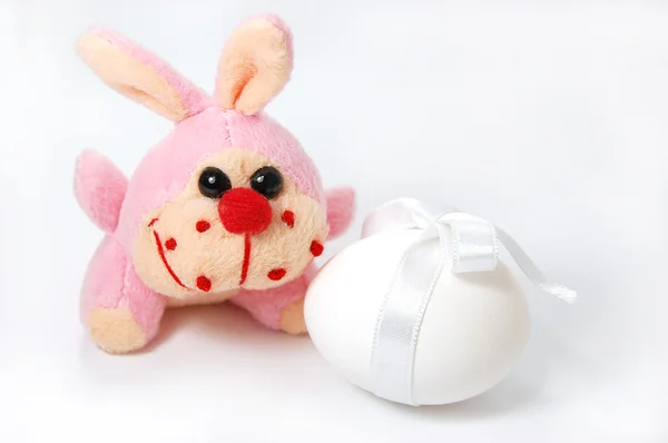 Toy bunny and white egg isolated on white — Stock Photo, Image