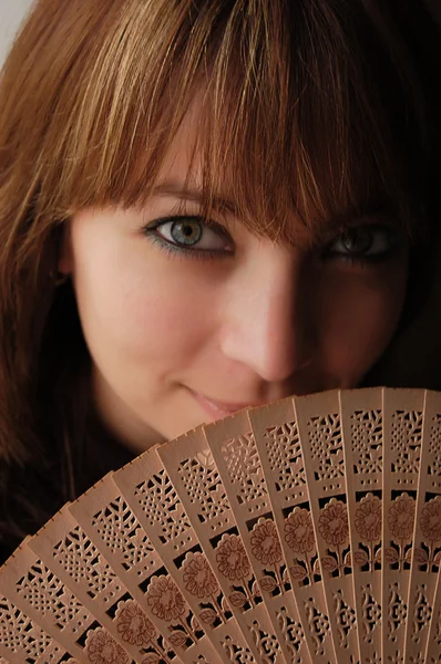 Menina de cabelos castanhos bonita com ventilador aberto — Fotografia de Stock