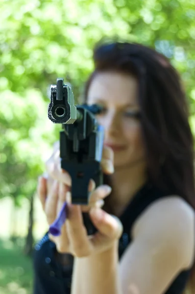 Woman aiming pneumatic gun — Stock Photo, Image