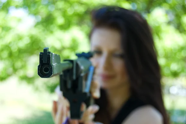 stock image Woman firing with pneumatic gun