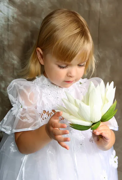 Girl in a white dress with a lily — Stock Photo, Image