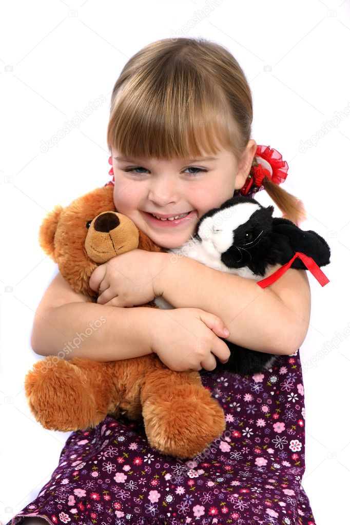 Girl embracing favorite toys