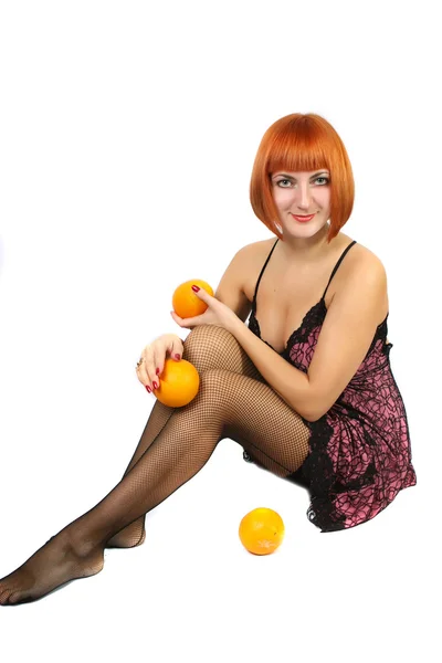Girl in a beautiful dress with oranges — Stock Photo, Image