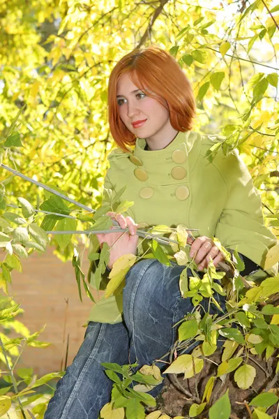 Girl in yellow leaves — Stockfoto