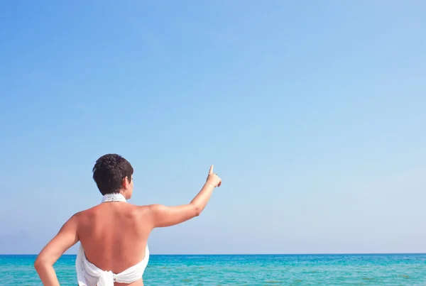 Woman pointing to the sea — Stock Photo, Image
