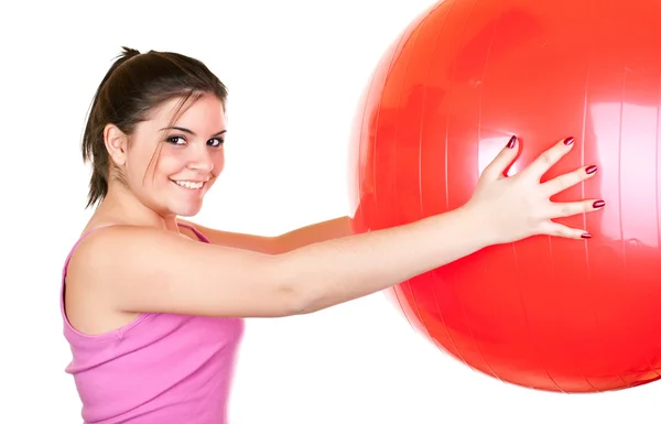 Девушка в розовом упражнения с мячом — стоковое фото