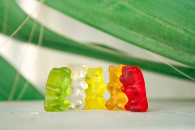 Colorful gummy bears having fun clipart