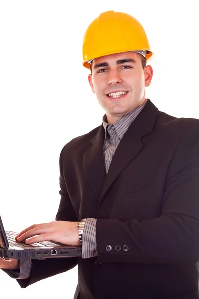 Zakenman met helm en laptop — Stockfoto