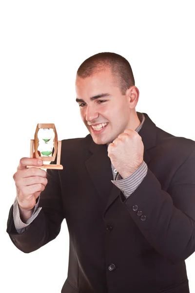 Успешный бизнесмен держит песочные часы — стоковое фото