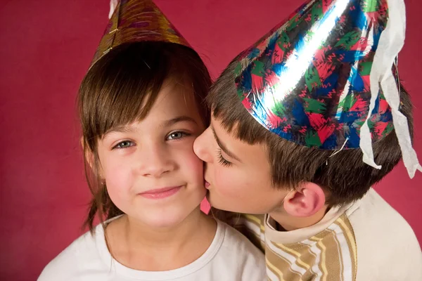 Boy and girl in christmas caps — Stock Photo, Image