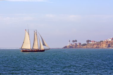 Schooner sails past Point Loma clipart