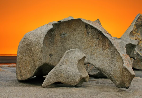 Sculpted rock formation and orange sky — Stock Photo, Image