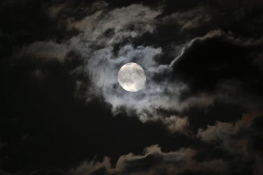 Full moon in eerie white clouds