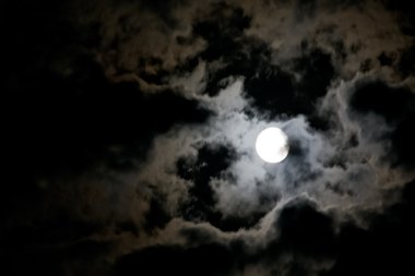 White full moon and eerie white clouds clipart