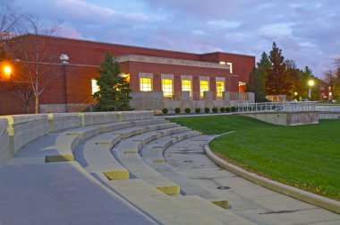 Building on a university campus at night clipart