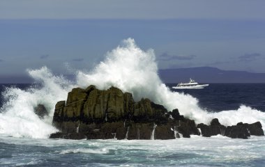 Waves breaking over rocks clipart