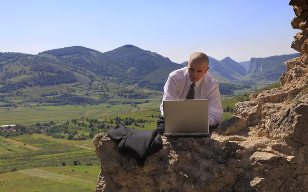 Businessman on a computer outdoors — Stock Photo, Image