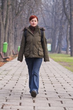 Teenager walking in a park