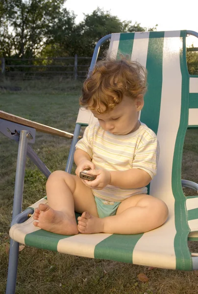 Little boy sitting in a deckchair — Stock Photo, Image