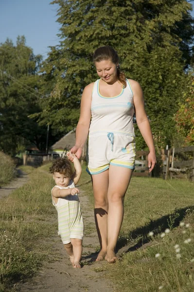 stock image Mother and son walking in the garden