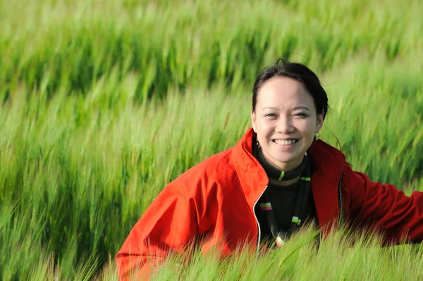 Asian woman grass in red — Stock Photo, Image