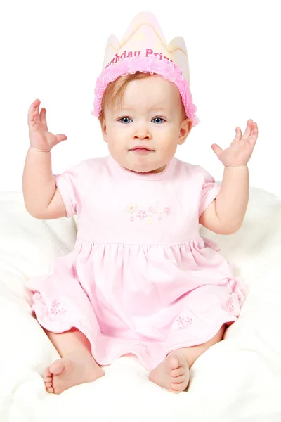 Doğum günü şapkası ve hava üzerinde el ile kız bebek — Stok fotoğraf