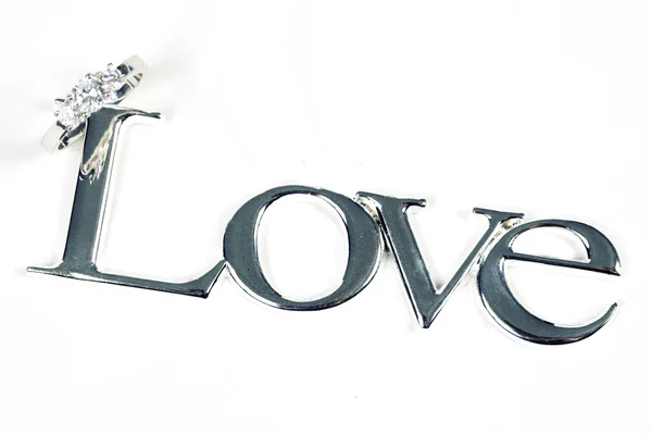 Word LOVE in silver metal with ring — Stock Photo, Image