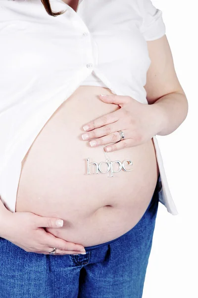 Hoffnungszeichen am Bauch einer Schwangeren — Stockfoto