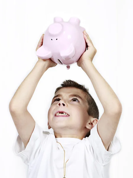 Giovane ragazzo tenendo su Piggy Bank — Foto Stock