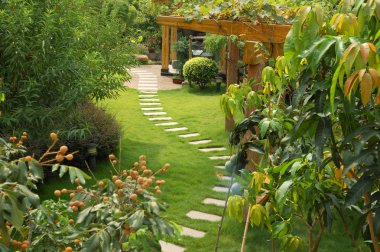 A stone walkway winding its way through a tranquil garden clipart