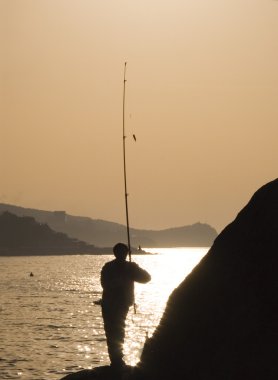 Silhouette of the fisherman clipart