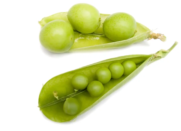 Pod of a green peas and fruits plums — Stock Photo, Image