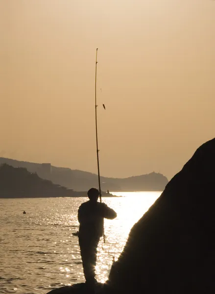 stock image Silhouette of the fisherman