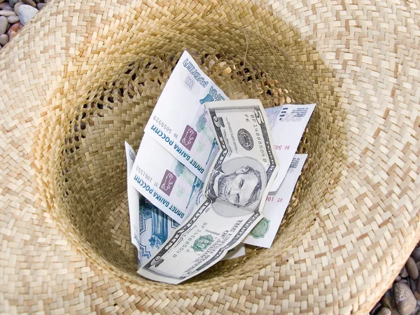 Money in hat — Stock Photo, Image