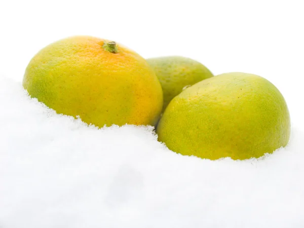 Three tangerines on snow — Stock Photo, Image