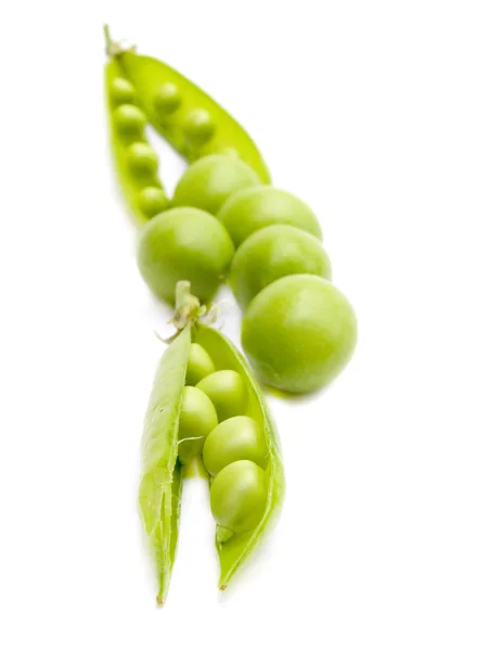 Green peas and plum — Stock Photo, Image