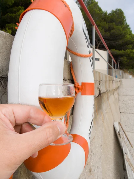 Wine-glass and a lifebuoy ring — Stock Photo, Image