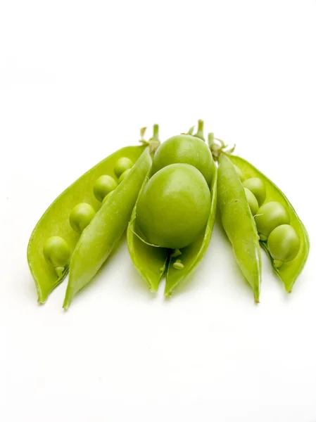 Fruits plums in a pod of a green peas. — Stock Photo, Image