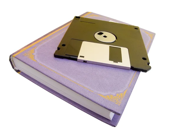 O livro e disquete de um computador — Fotografia de Stock