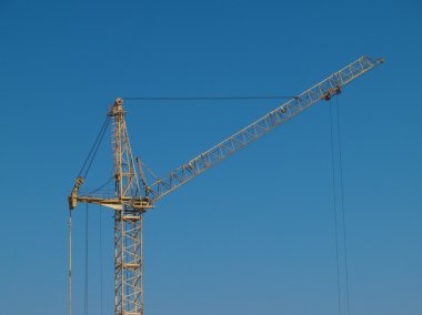 Yellow crane on blue sky clipart