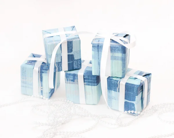 Gifts in blue packing with a white tape — Stock Photo, Image