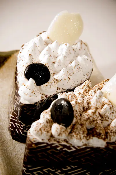 Two cakes with chocolate and cream