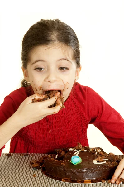 Ребенок ест шоколадный торт — стоковое фото